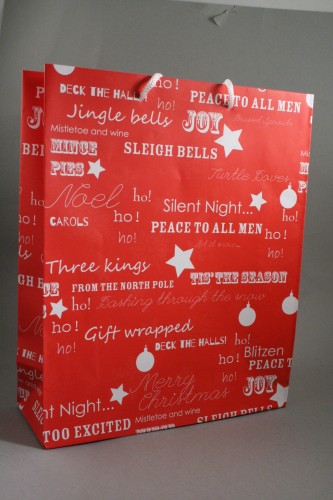 Red Christmas Gift Bag with White Festive Christmas Writing and White Cord Handles. . Size Approx 32cm x 26cm x 10cm.