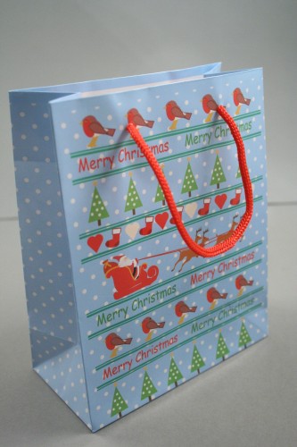 Merry Christmas Giftbag with Robins, Trees, Santa and Reindeer on a Blue Background with Red Cord Handles. Approx Size 15cm x 12cm x 6cm