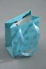 Turquoise Gift Bag with Snowflake Glitter Print. Ribbon Handles. Approx Size 11cm x 9cm x 5cm - view 1